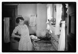 A woman doing laundry at a sink