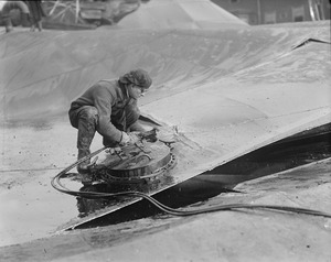 Tank cut into sections with acetylene torch in search of bodies underneath Molasses Disaster