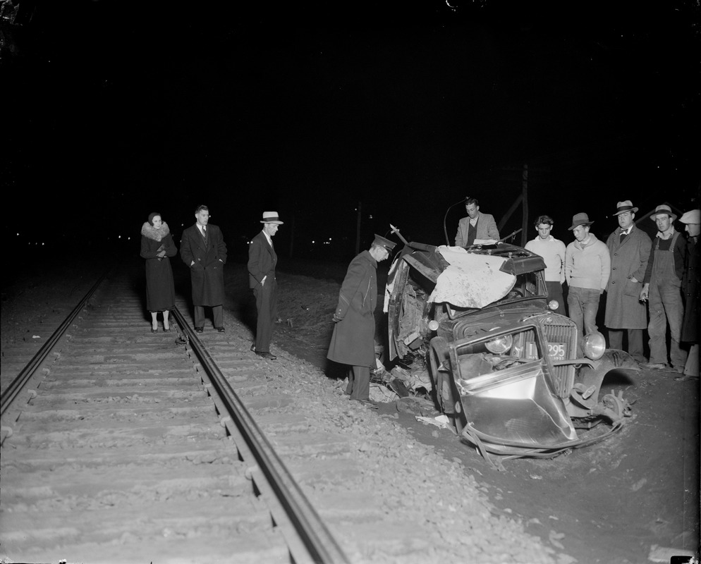 Auto hit by train kills two. Belmont