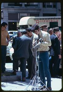 Man and microphones in Post Office Square, Boston, for arraignment of Daniel Ellsberg