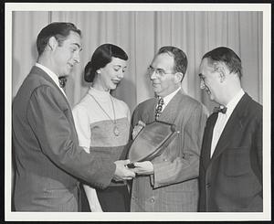 For Immediate Release. Mr. Harry Scheft, President, H. Scheft Company, 150 Lincoln St., Boston, will receive the “Brand Name Retailer of the Year” plaque which Henry E. Abt, President of Brand Names Foundation, Inc., (center) is showing “Your Show of Shows” television stars Sid Caesar, Gloria Stevens of The Hamilton Trio, and director-producer Max Liebman. The H. Scheft Company won the top award in the shoe store class from 6,000 entries in the Foundation’s 4th annual national competition. The presentation is to be made on April 16 at the Brand Names Day dinner at the Waldorf-Astoria, New York City, before more than 2,000 civic and business leaders. Sid Caesar, Imogene Coca, and The Hamilton Trio, will headline the entertainment at the dinner. James A. Farley, Chairman of the Board of The Coca-Cola Export Corporation, and former Postmaster general of the United States, is to be the keynote speaker.