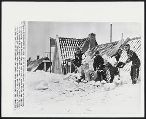 Roof-High In Snow In The Netherlands - Villagers of Volendam, the Netherlands, today begin digging out their homes which are almost completely buried by a ten-foot wall of snow. Villagers, mainly fisher were evacuated Thursday when heavy drifts buried a number of homes to the roof.