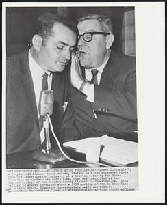 Whispered Words from Lawyer--Robert L.Bing,left, a 39-year-old Atlanta truck driver, listens to a few whispered words from his lawyer,Lester Chalmers, at a hearing today by the House Committee on Un-American Activities. Bing was identified as the Exalted Cyclops of the Clayton County Klavern in Jonesboro,Ga., Bing refused to answer questions about a 1958 meeting of the Ku Klux Klan in Atlanta which, committee investigators said, was held to consolidate the various Klans.