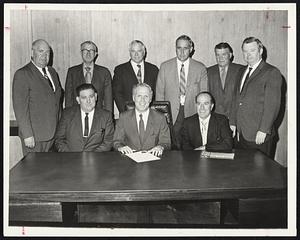 Mayor Kevin White, front center, calls for the "restoration of our merchant marine" in special proclamation proclaiming National Maritime Day. Seated, front left, is Edward Riley, Boston port agent, Seafarers International Union and secretary-treasurer, Greater Boston and New England Maritime Trades Council, AFL-CIO and seated right, Pat Bocanfuso, the Council's president. Participating also, standing, from left: Lawrence Sullivan, Greater Boston Labor Council: John O'Brien, Business Manager, Local 103, International Brotherhood of Electrical Workers; Fred Ramsey, secretary-treasurer, Metropolitan Boston Building and Construction Trades Council; Carl Bucci, Local 4, Portable Engineers; James Martin, Atlantic Fisherman's Union and Harry O'Donnell, Elevator Construction Union.