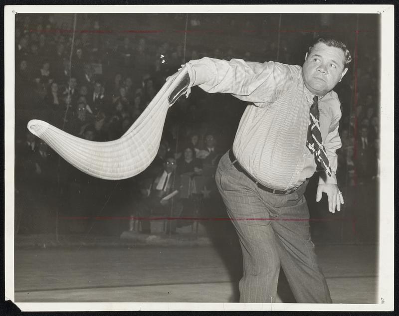 It's Babe Ruth -- But What is That. That, children, is a cesta, the equivalent of a bat -- the Bambino of Swat knows a thing or two about bats -- in the game of jai-alai. The idea is to swat a pelota with it, but it's a lot harder than hitting a ball, as Ruth found out at the Hippodrome, New York, Oct. 20, when he tried his skill at this new popular sport. Babe Ruth tries his hand at Jai Alai.