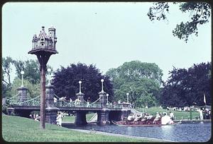 Boston Public Garden footbridge, lagoon and swan boat, miniature castle on post in foreground