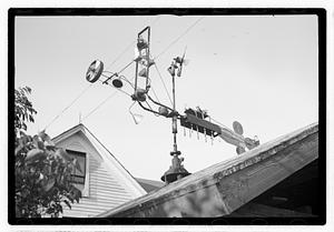 An elaborate device on roof, possibly a weather vane