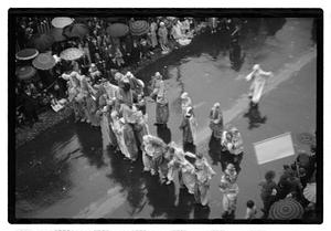 People walking in a rainy parade