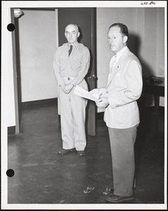 Two men, one with award