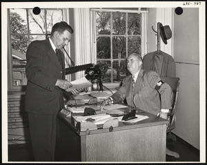A.E. Cowie and man at desk