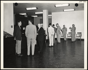 Officers and men observing exhibit