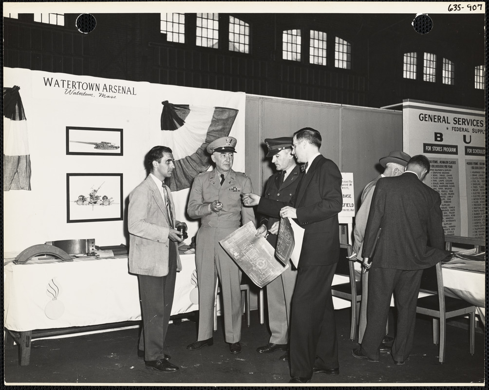 Men and officers with plans at Watertown Arsenal exhibit