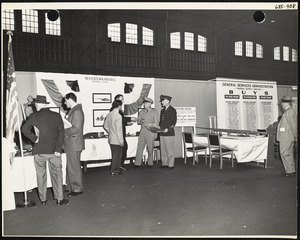 Men and officers with plans at Watertown Arsenal exhibit