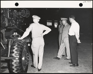 Officers in factory with vehicle