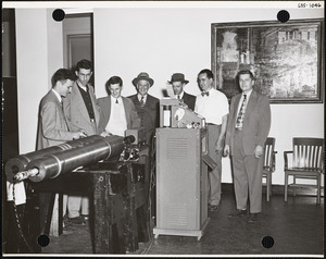 Men viewing ordnance exhibit