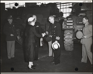 Naval officer shaking hands with woman
