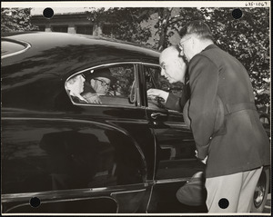 Military officers at window of vehicle