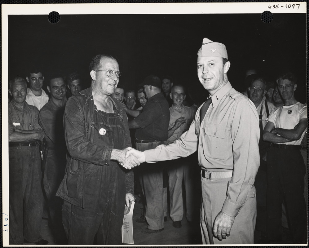 Soldier and worker shaking hands