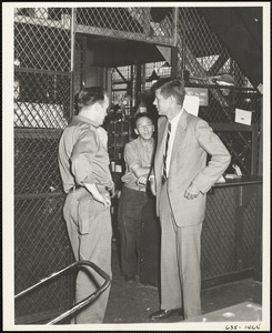 John F. Kennedy with two men