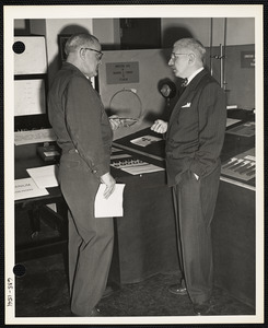 Two men talking near exhibit