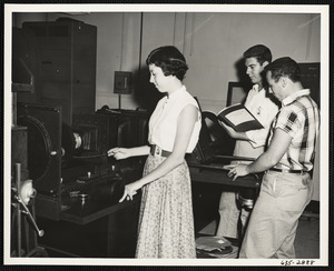 Woman and two men testing machine