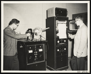 Two men testing machines