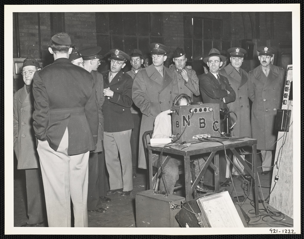 Spectators group around National Broadcasting Company, engineer during preparation for Army Hour broadcast from the foundry of Watertown Arsenal, Watertown, Massachusetts in conncetion with casting of the 100,000th gun barrel on 20 February 1994