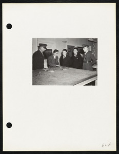 Military officers and men inspecting macrograph laboratory