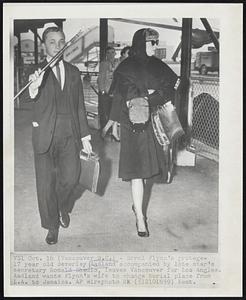 Errol Flynn's protege--17 year old Beverley Aadland accompanied by late star's secretary Ronald Shedlo, leaves Vancouver for Los Angles. Aadland wants Flynn's wife to change burial place from L.A. to Jamaica.
