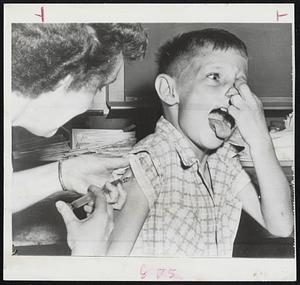 Crossed Fingers, crossed eyes and tongue exercises proved to be the formula needed to “beat the needle” for little Bobby Godfrey in Columbus, Ga. This was the youngster’s second polio shot.