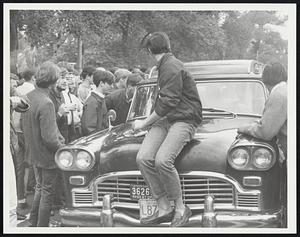 Beacon St. near Park St. Airport Limousine in front of State House surrounded by kids, harassing them.