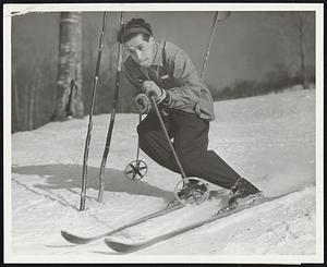 Herbert Scheider, son of Hannes Schneider, world famous ski instructor, is a ski instructor in his own right at the famous ski school at Eastern Slope Inn, will make his first appearance in the national championships meet at Aspen, Colorado, March 8th and 9th. His father okayed his entry after watching him train with Toni Matt this winter on Cranmore Mt., North Conway, N.H. Photo shows Herbert Schneider going thru the flush on Mt. Cranmore. Sticking the tongue out helps.