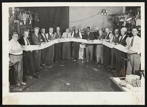 Some Job for the Censor-William McKinnon of Dorchester (seventh from left) , clerk at the South postal station and veteran of this war, wrote this 100-foot letter in fine handwriting to Cpl. Charles T. Linehan, USA, now in Italy, formerly employed at the same postoffice. McKinnon writes letters to former employes in the service, has written many 50 feet long. The picture was made by Samuel Corman, postal employe.