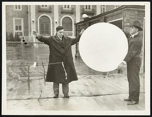 Balloons Carry Weather Recording Instruments. Photo shows one of 35 balloons equipped with weather recording instruments released in St. Louis, Mo., Nov.21, by students of the Massachusetts Institute of Technology for a study of the stratosphere. Rewards were offered for the return of the recording devices.