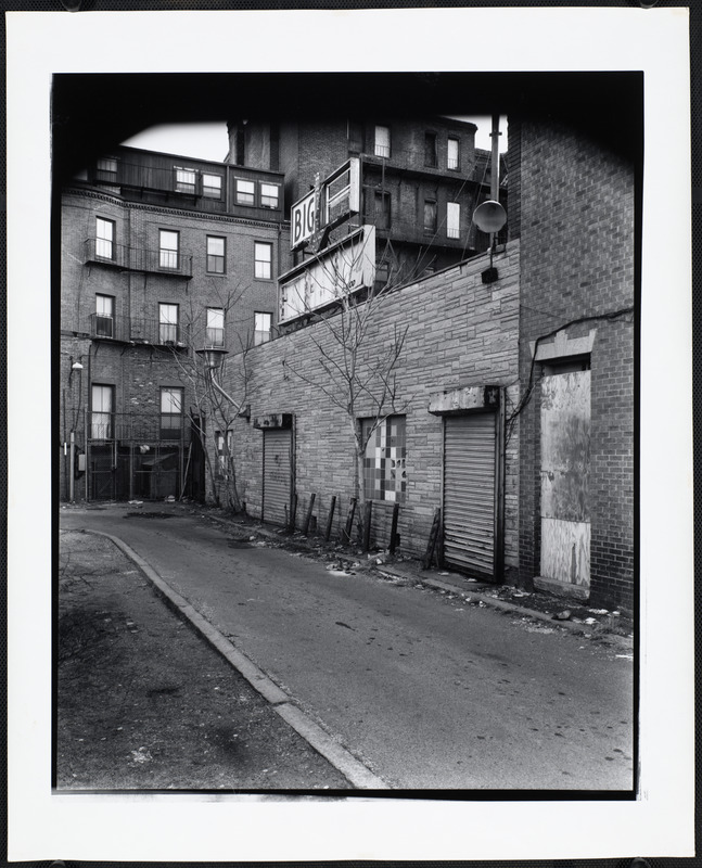 Side of building with roll-up door, with sign above that reads "Big".