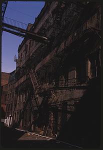 View of building with fire escapes and walkway