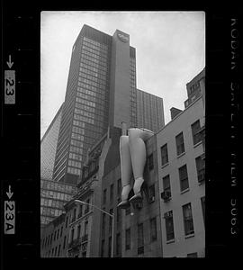 Inflatable legs hang from side of building, New York City