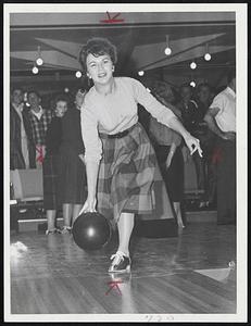Mrs. Don Simmons, wife of Boston Bruins' goalie, seems to be enjoying herself while bowling. Mrs. Simmons, her husband, and other Bruins and their wives were competing at a Bruins' night at Beverly's Go-Go Bowling Lanes last night.