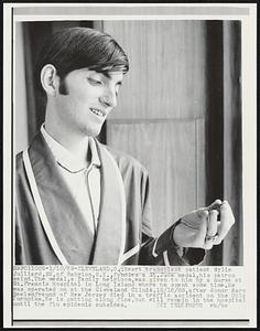 Heart transplant patient Wylie Julliard, 22, of Babylon, N.Y., fondles a St. Jude medal, his patron saint. The medal, a family heirloom, was given to him by a nurse at St. Francis Hospital in Long Island where he spent some time. He was operated on at the Cleveland Clinic, 12/16/68, after donor Marc Seelenfreund of New Jersey died in a traffic accident on the Ohio Turnpike. He is getting along fine, but will remain in the hospital until the flu epidemic subsides.