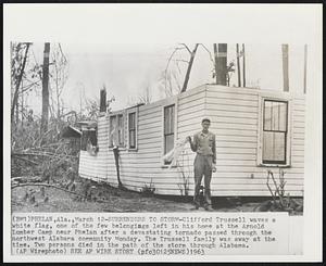 Phelan, Ala. - Surrenders To Storm - Clifford Trussell waves a white flag, one of the few belongings left in his home at the Arnold Lumber Camp near Phelan after a devastating tornado passed through the northwest Alabama community Monday. The Trussell family was away at the time. Two persons died in the path of the storm through Alabama.