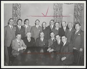 Smiles That Came Hard - Mayor Kerrigan (center, seated), surrounded by city council at a farewell get-together at the Parker House yesterday. Left to right, seated: Thomas Shannon, Thomas J. Hannon, Mayor Kerrigan, Michael P. Feeney, Perlie Dyar Chase and Charles R. Taylor. Standing left to right: Isadore H. Y. Muchnick, John B. Kelly, Joseph Scannell, Maurice Sullivan, William Carey, Daniel Sullivan, Thomas McCormack, William Joseph Keenan, Philip Fish and Joseph Russo.