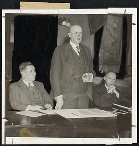 Mayor Mansfield, center, shown as he addressed civic and industrial leaders yesterday in preparation for a clean-up campaign for Boston. At his left is Edward W. Roemer, building commissioner and chairman of the cleanup, fix-up campaign; and at his right is C. A. Dana Redmond, secretary of the committee.
