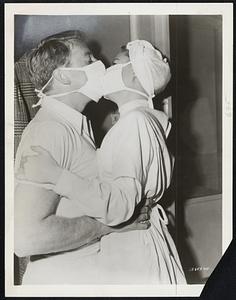 Sanitary! – Hollywood film censors can’t kick at this kiss, between Van Johnson and June Allyson in “High Barbaree.” In the film June is a nurse and Van an ex-medical student.