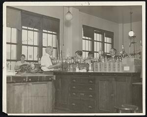 Laboratory of [illegible] food bureau. L to r. Ms. Carrie S. Conlon, Charles H Hickey, Miss [Jane?] Whitney, Paul L. Leavitt, Herman W. [Hoyes?]