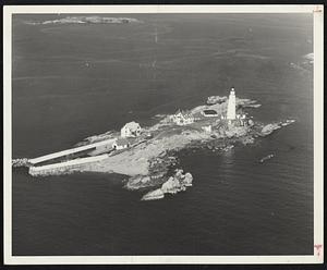 Two Famous Landmarks as seen from the air in pictures taken by Navy Chief Aviation Photographer's Mate James M. Ross of Quincy from a helicopter out of Squantum Naval Air Station. Left is Boston Lighthouse.
