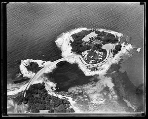 An house on a small island, attached by a bridge