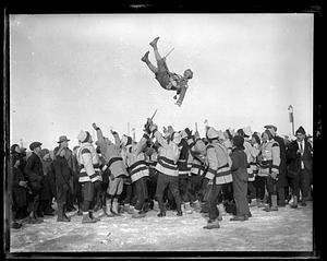 A person being thrown up in the air by a crowd