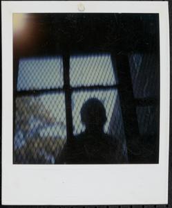 Boy in front of a fence