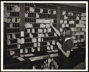 NYA student aid recipient in charge of post office at State Teachers College