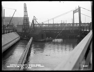 Distribution Department, Low Service Pipe Lines, driving piles, Chelsea North Bridge Tunnel, Mystic River; Charlestown; Chelsea, Mass., Aug. 31, 1900